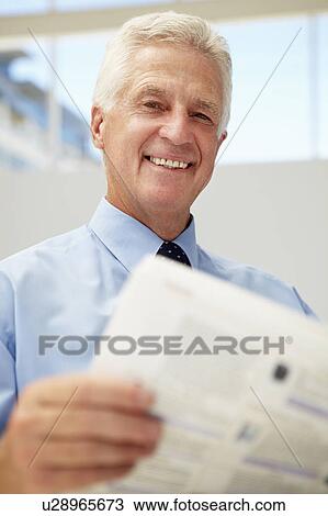 Senior businessman reading document View Large Photo Image Stock Image - Senior businessman reading document. Fotosearch