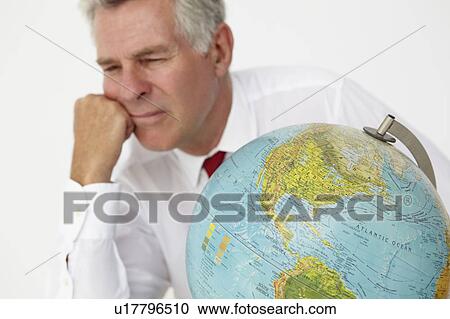 Stock Image - Senior businessman with globe. Fotosearch