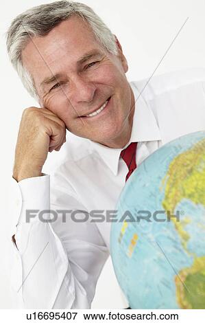 Senior businessman with globe View Large Photo Image Stock Photo - Senior businessman with globe. Fotosearch