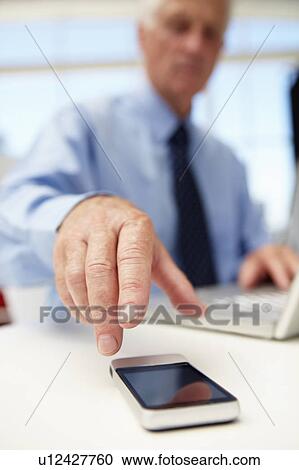 Senior businessman with laptop and phone View Large Photo Image Stock Image - Senior businessman with laptop and phone. Fotosearch