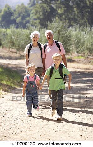Senior couple and grandchildren on country walk View Large Photo Image Stock Image - Senior couple and grandchildren on country walk. Fotosearch