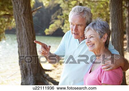 Stock Photograph - Senior couple at lake together. Fotosearch