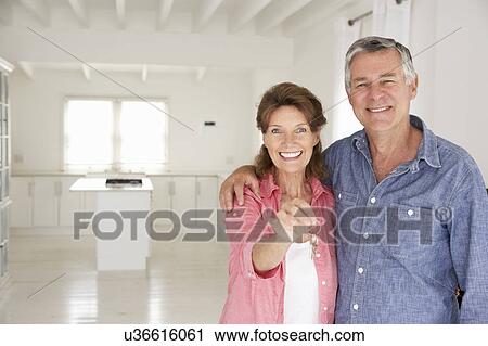 Stock Image - Senior couple in new home. Fotosearch