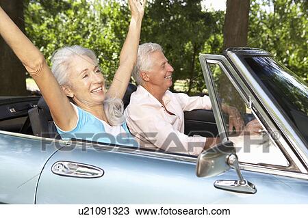 Stock Image - Senior couple in sports car. Fotosearch