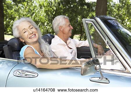 Stock Photo - Senior couple in sports car. Fotosearch