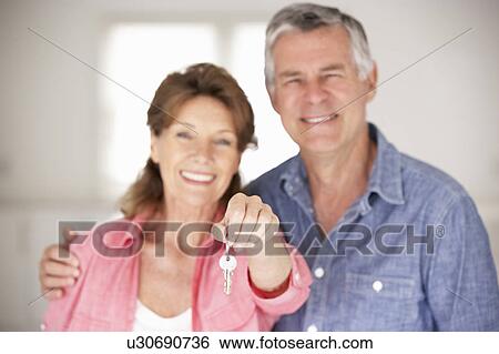 Stock Photograph - Senior couple moving into new home. Fotosearch
