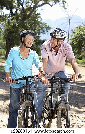 Stock Image - Senior couple on country bike ride. Fotosearch