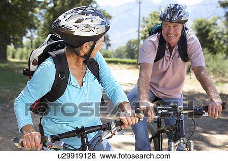 Stock Photo - Senior couple on country bike ride. Fotosearch