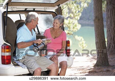 Stock Image - Senior couple on country picnic. Fotosearch