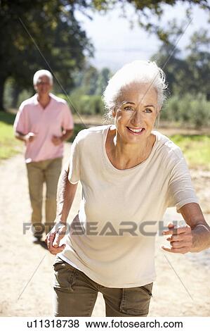 Stock Photo - Senior couple on country run. Fotosearch