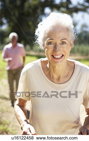 Stock Photo - Senior couple on country run. Fotosearch