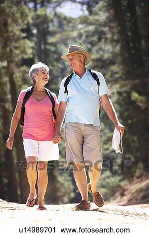 Stock Image - Senior couple on country walk. Fotosearch