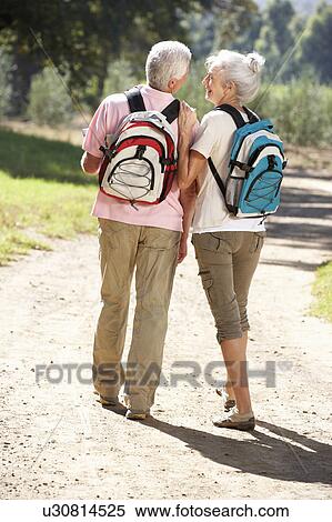 Stock Photography - Senior couple on country walk. Fotosearch