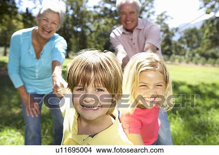 Senior couple on country walk with grandchildren View Large Photo Image Picture - Senior couple on country walk with grandchildren. Fotosearch