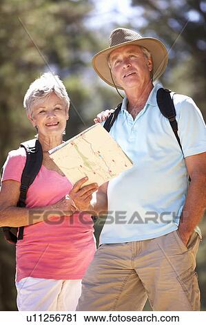 Senior couple reading map on country walk View Large Photo Image Stock Image - Senior couple reading map on country walk. Fotosearch