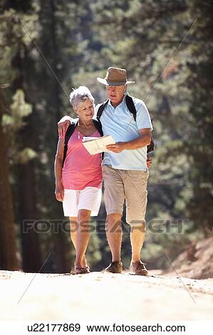 Senior couple reading map on country walk View Large Photo Image Stock Photo - Senior couple reading map on country walk. Fotosearch