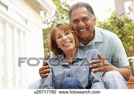 Stock Image - Senior couple relaxing in garden. Fotosearch