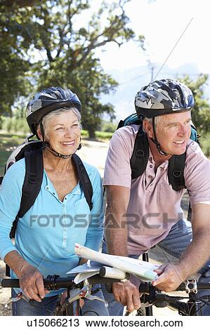 Senior couple with map on country bike ride View Large Photo Image Stock Image - Senior couple with map on country bike ride. Fotosearch