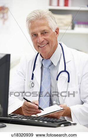 Stock Photo - Senior doctor at desk. Fotosearch