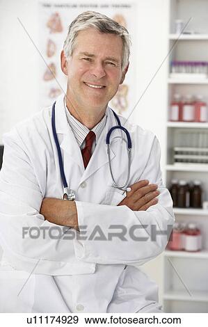 Stock Photo - Senior doctor in consulting room. Fotosearch