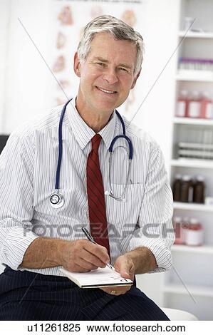 Stock Photography - Senior doctor writing prescription. Fotosearch