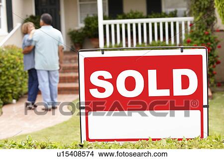 Picture - Senior Hispanic couple moving into new home. Fotosearch