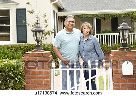 Senior Hispanic couple outside home View Large Photo Image Picture - Senior Hispanic couple outside home. Fotosearch