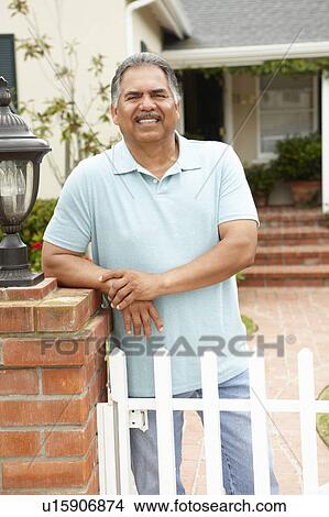Picture - Senior Hispanic man outside home. Fotosearch