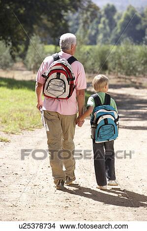 Senior man and grandson on country walk View Large Photo Image Picture - Senior man and grandson on country walk. Fotosearch