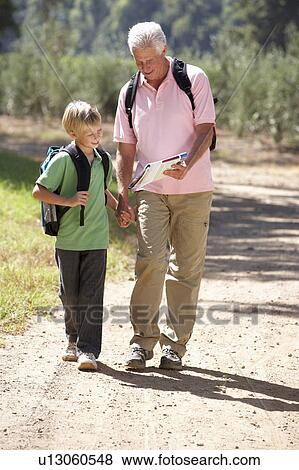 Stock Photo - Senior man and grandson on country walk. Fotosearch