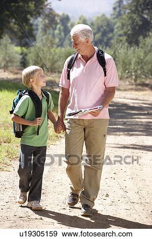 Senior man and grandson on country walk View Large Photo Image Stock Photo - Senior man and grandson on country walk. Fotosearch