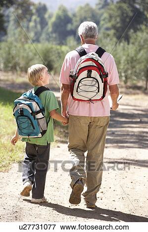 Senior man and grandson on country walk View Large Photo Image Stock Photo - Senior man and grandson on country walk. Fotosearch