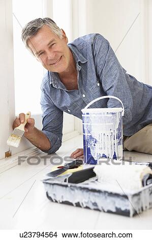 Picture - Senior man decorating house. Fotosearch