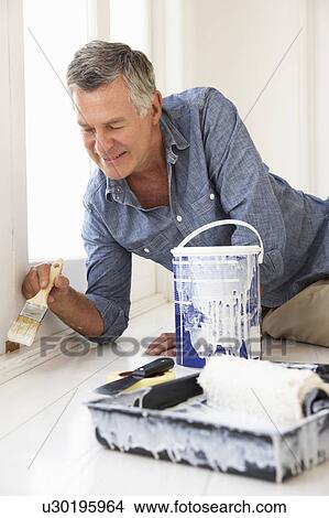 Picture - Senior man decorating house. Fotosearch