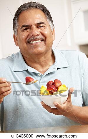Senior man eating fruit View Large Photo Image Stock Image - Senior man eating fruit. Fotosearch