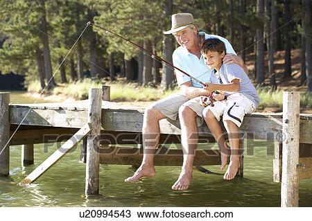 Senior man fishing with grandson View Large Photo Image Stock Image - Senior man fishing with grandson. Fotosearch