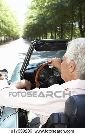Stock Photograph - Senior man in sports car. Fotosearch