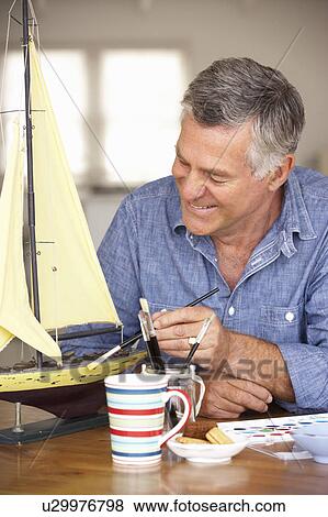 Senior man model making View Large Photo Image Stock Photo - Senior man model making. Fotosearch