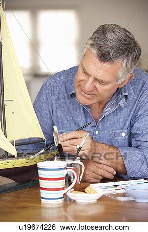 Stock Photograph - Senior man model making. Fotosearch