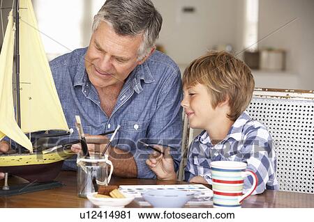 Senior man model making with grandson View Large Photo Image Stock Image - Senior man model making with grandson. Fotosearch
