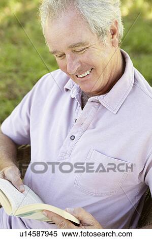 Stock Photography - Senior man reading a book. Fotosearch