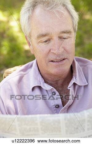 Stock Photograph - Senior man reading newspaper. Fotosearch