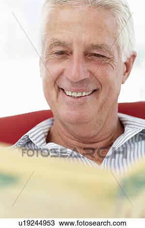 Stock Image - Senior man reading. Fotosearch