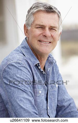 Stock Photo - Senior man sitting outdoors. Fotosearch
