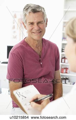 Picture - Senior man visiting doctor. Fotosearch