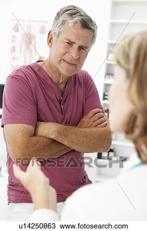 Stock Image - Senior man visiting doctor. Fotosearch