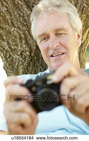 Senior man with camera View Large Photo Image Picture - Senior man with camera. Fotosearch