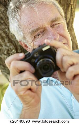 Senior man with camera View Large Photo Image Stock Image - Senior man with camera. Fotosearch