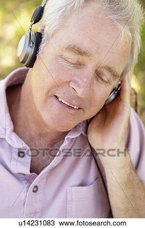 Stock Image - Senior man with headphone. Fotosearch
