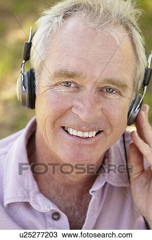 Stock Image - Senior man with headphone. Fotosearch
